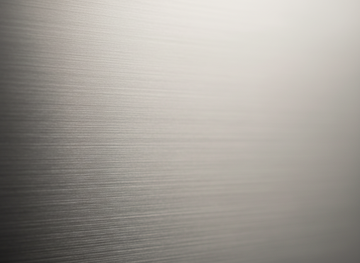 Abstract close-up of a brushed matte metal surface with soft directional lighting